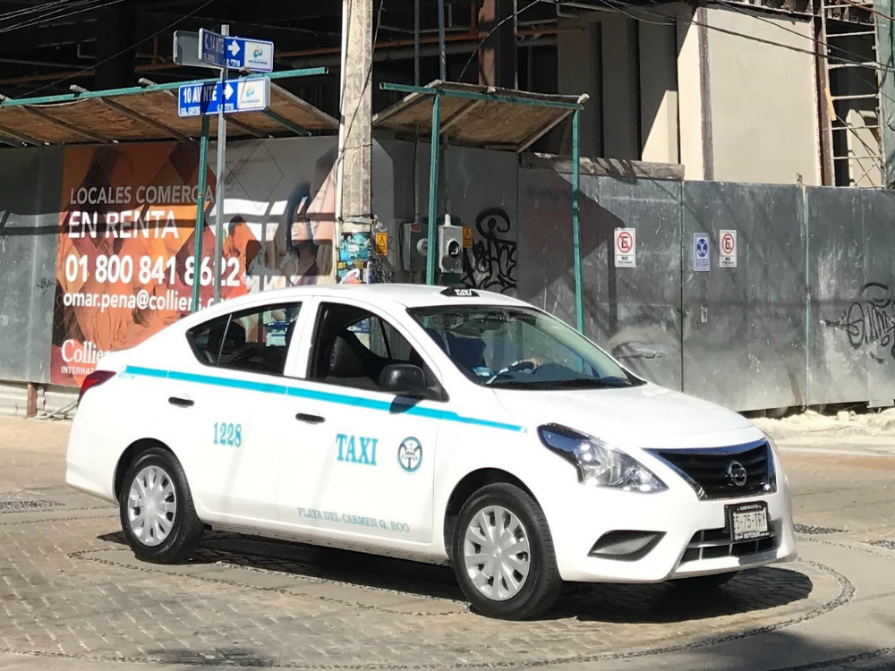 A Playa del Carmen Taxi driving down the street in Playa del Carmen Mexico