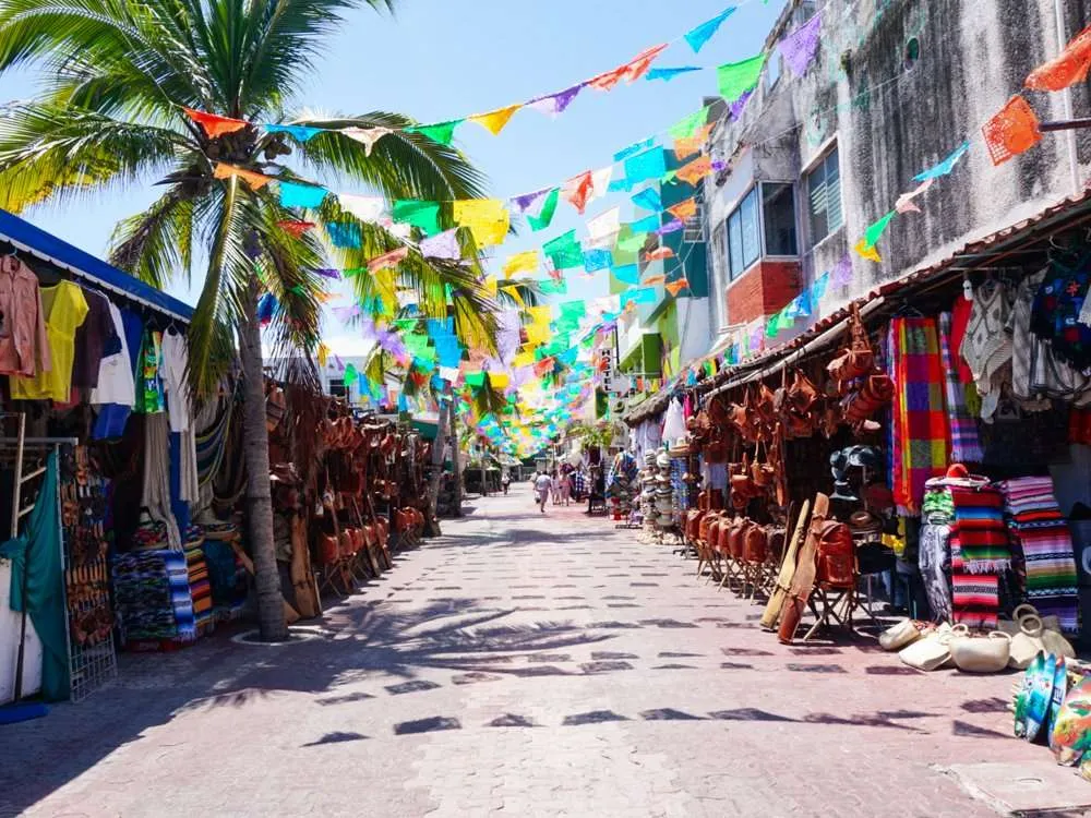 Colorful flags hanging across 5th Avenue shopping in Playa del Carmen