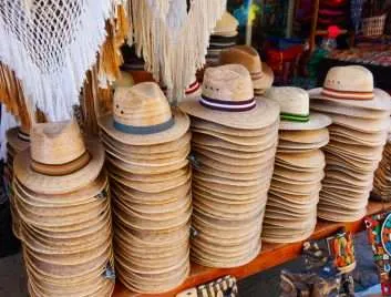 Piles of straw Fedora hats at a souvenir shop in Mexico