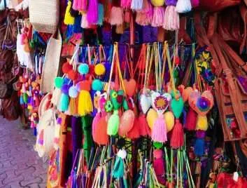 An assortment of colorful woven purse pom-poms at a souvenir shop in Mexico