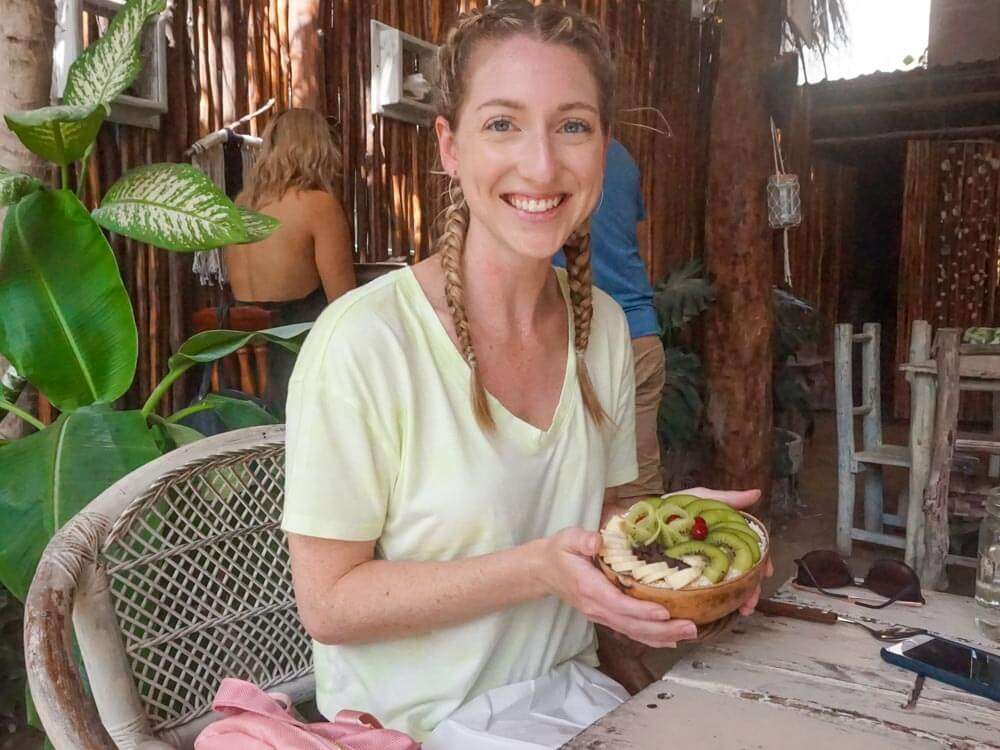 A girl eating a smoothie bowl at Painapol Holbox