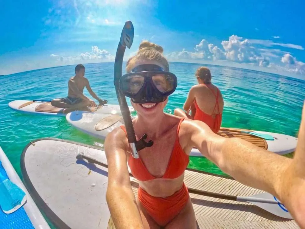 Me wearing a snorkel mask on a paddle board in Playa del Carmen Mexico