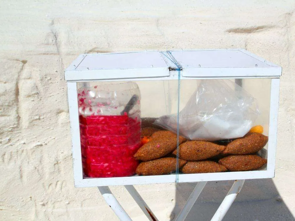 A box filled with kibis and pickled onions