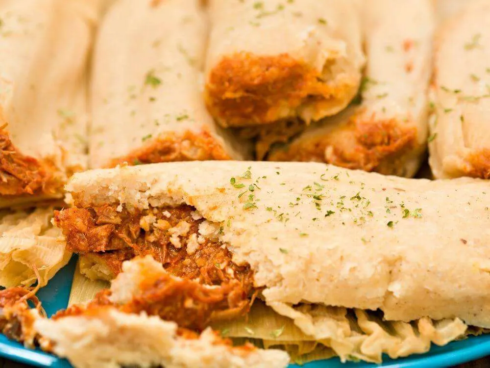A plate of tamales filled with meat