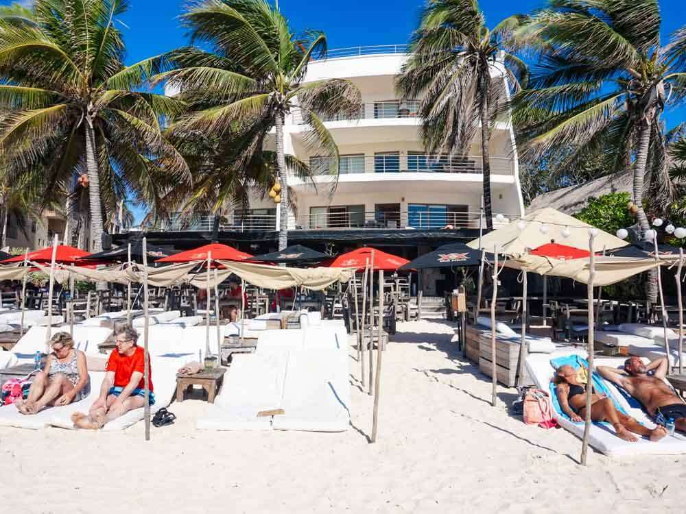 People lounging on lounge beds at Zenzi Beach Club Playa del Carmen