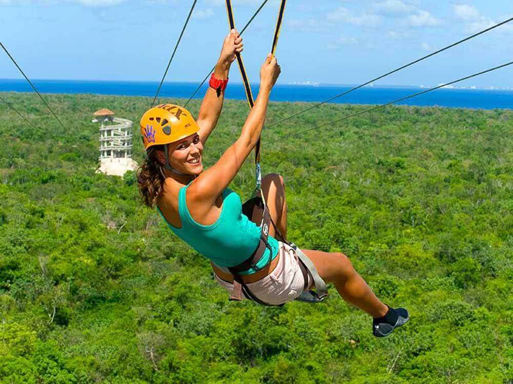 A woman ziplining at Xplor adventure park