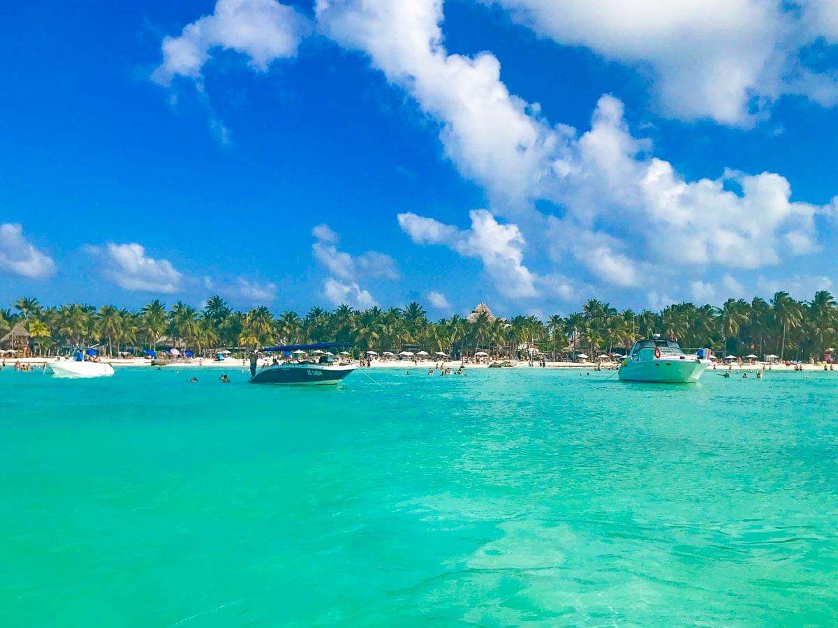 Boats anchored in the water off shore at Playa Norte beach on Isla Mujeres