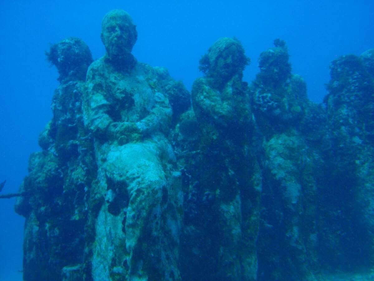 Underwater statues of people at the MUSA Underwater Museum of Art in Isla Mujeres