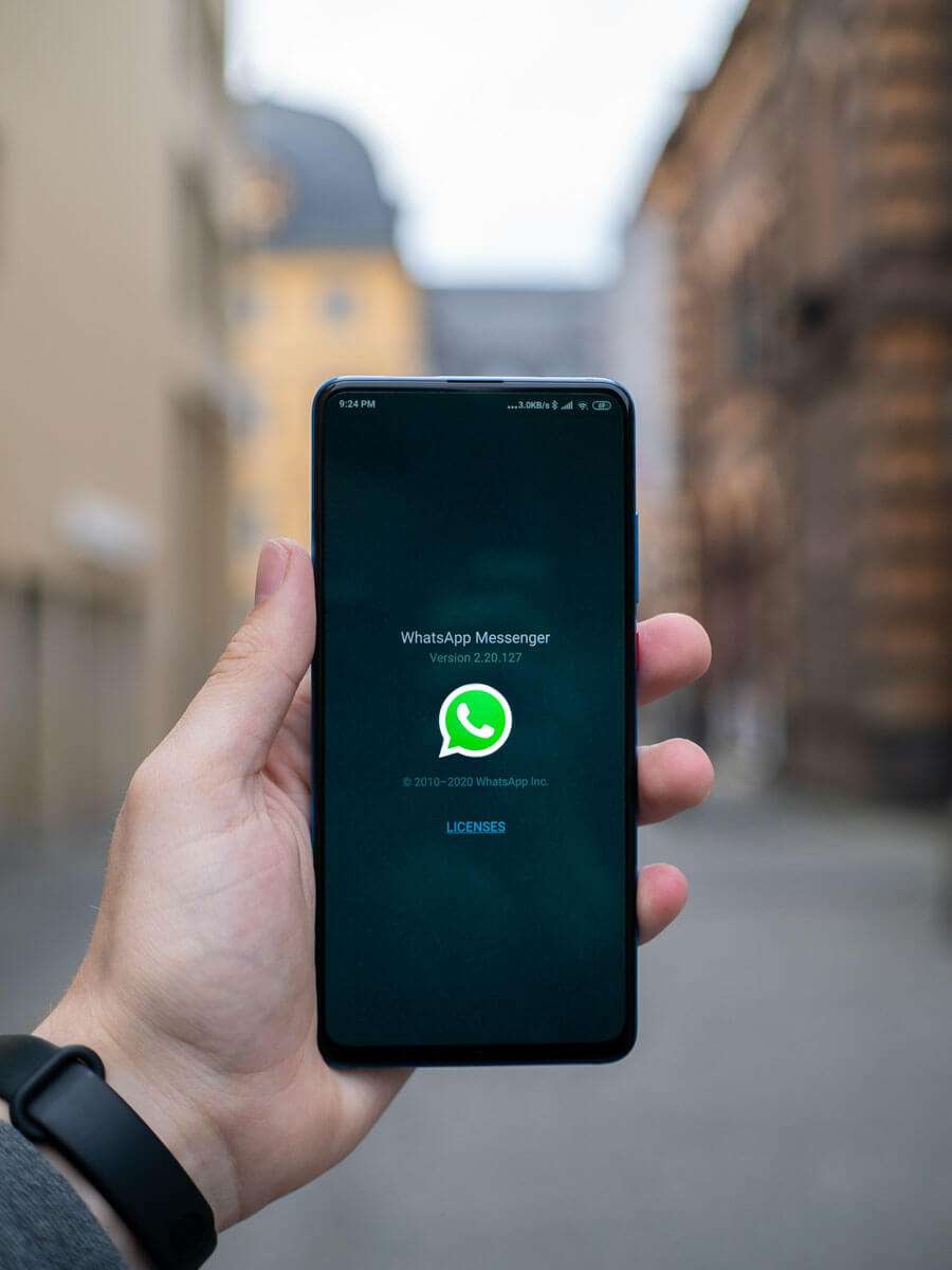 Man Holding a Phone with WhatsApp App on Screen