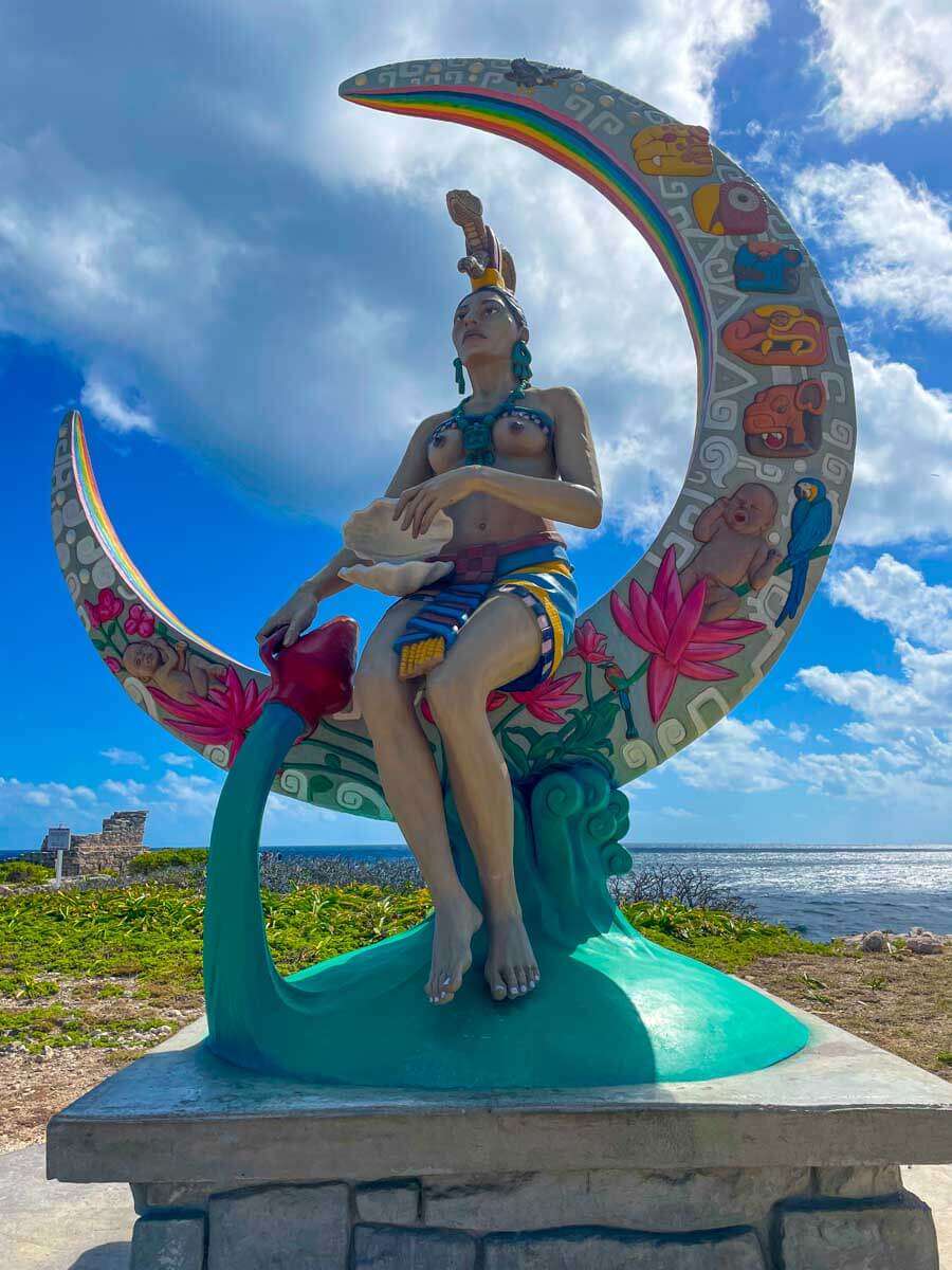 A statue of the goddess Ixchel sitting on a crescent moon at Punta Sur in Isla Mujeres