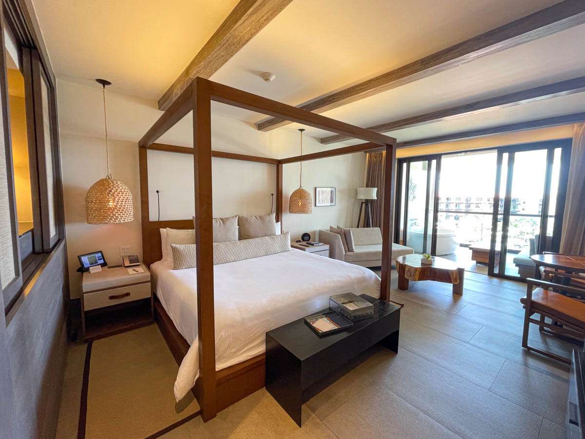 Ocean View Suite at Hotel Unico Riviera Maya with a king-sized four poster bed and wood accents and furnishings