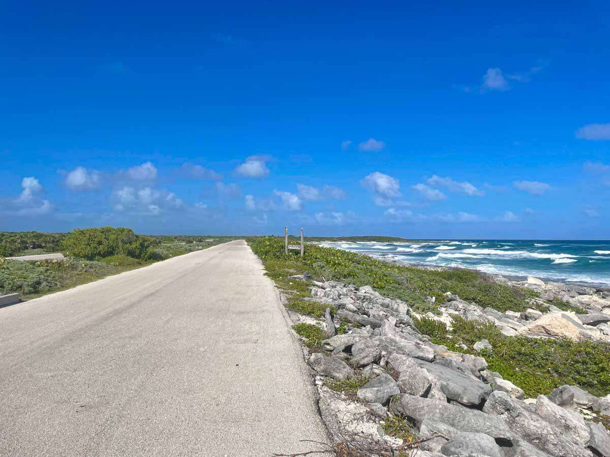 Long shot of the costal road in Cozumel next to the ocean