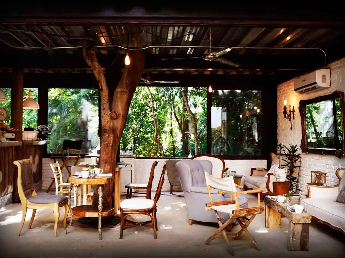 Rustic tables and chairs in the lobby at Hotel La Semilla Playa del Carmen