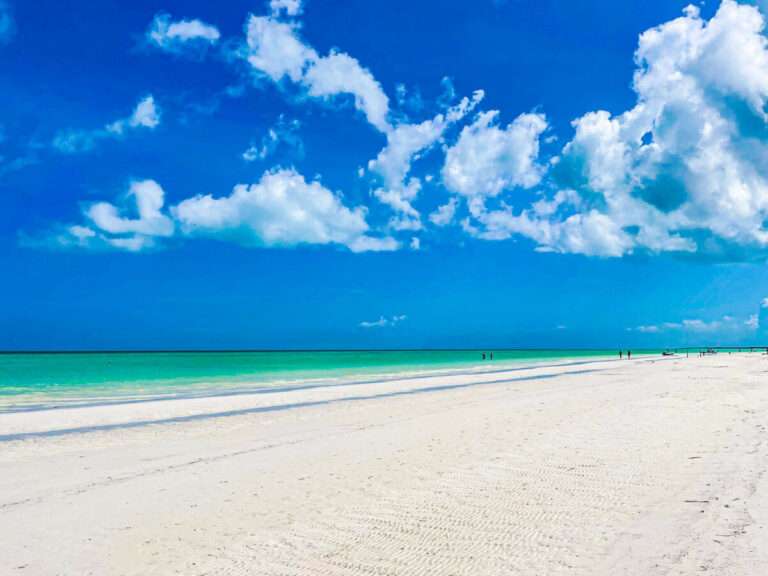 A wide and flat beach in Holbox Mexico with white sand and turquoise water