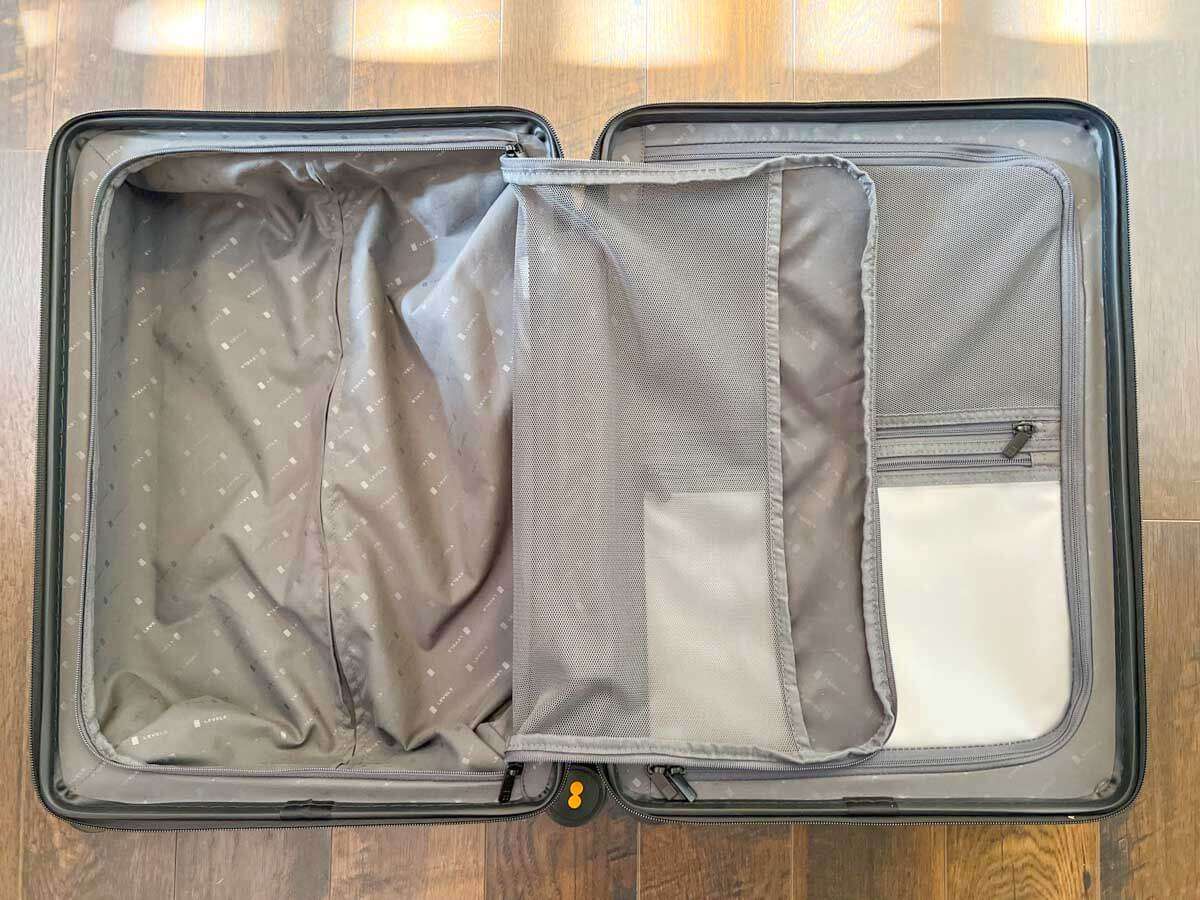 A view of the inside of the Level8 Voyageur Carry-On suitcase with zippered compartments