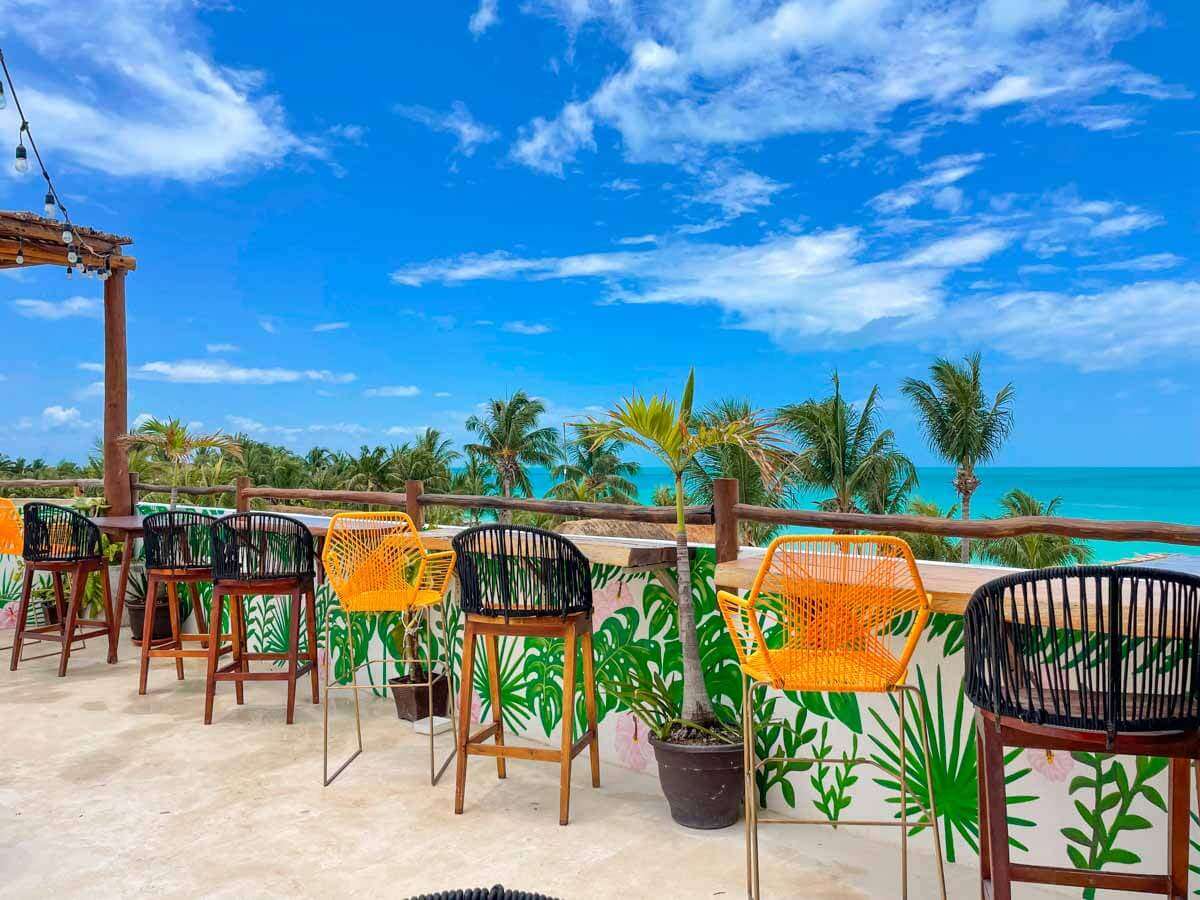 The rooftop bar at Mittoz Holbox with bar chairs overlooking the water