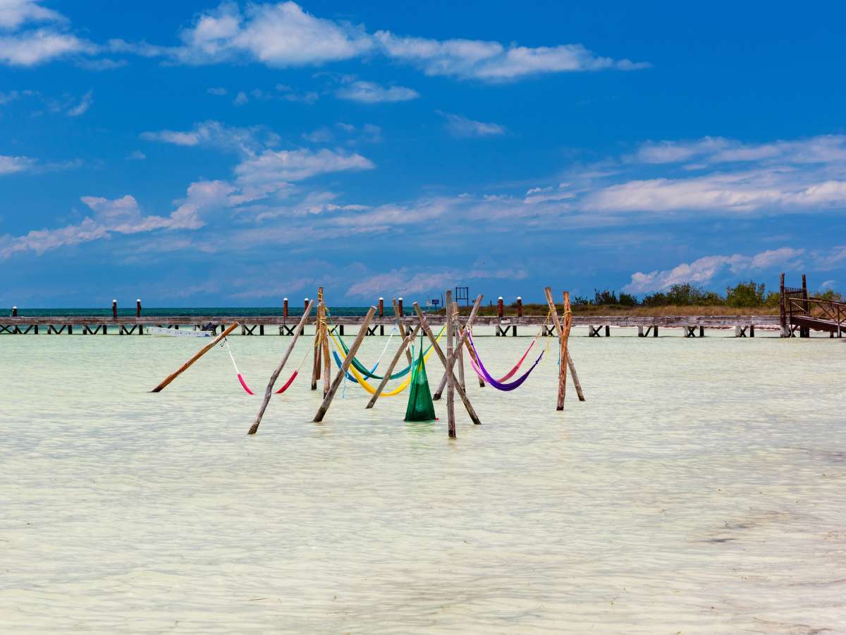 Hammocks in the water at Playa Punta Cocos in Holbox Mexico