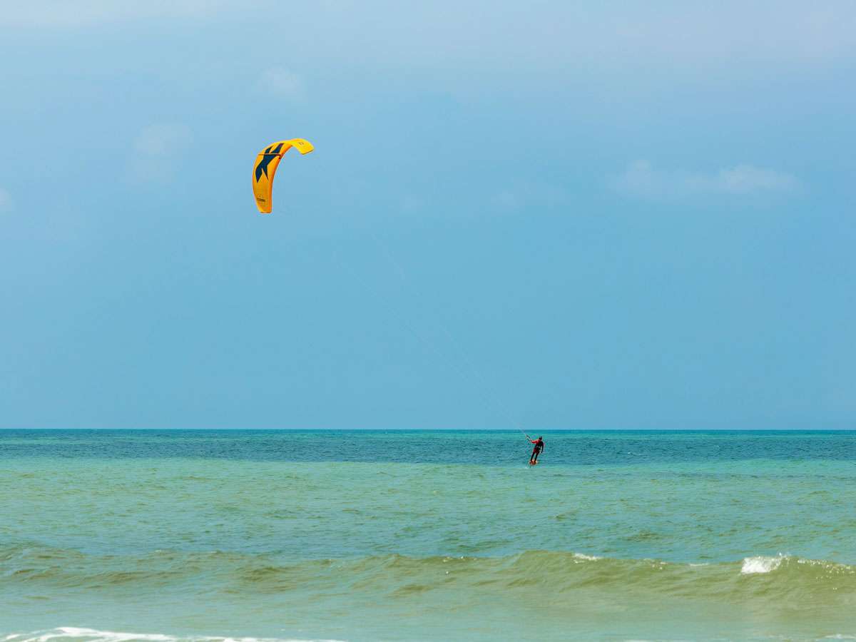 A person kitesurfing on the water in Holbox Mexico