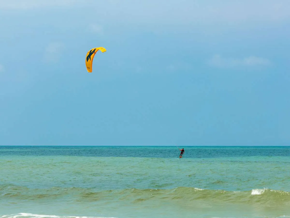 A person kitesurfing on the water in Holbox Mexico