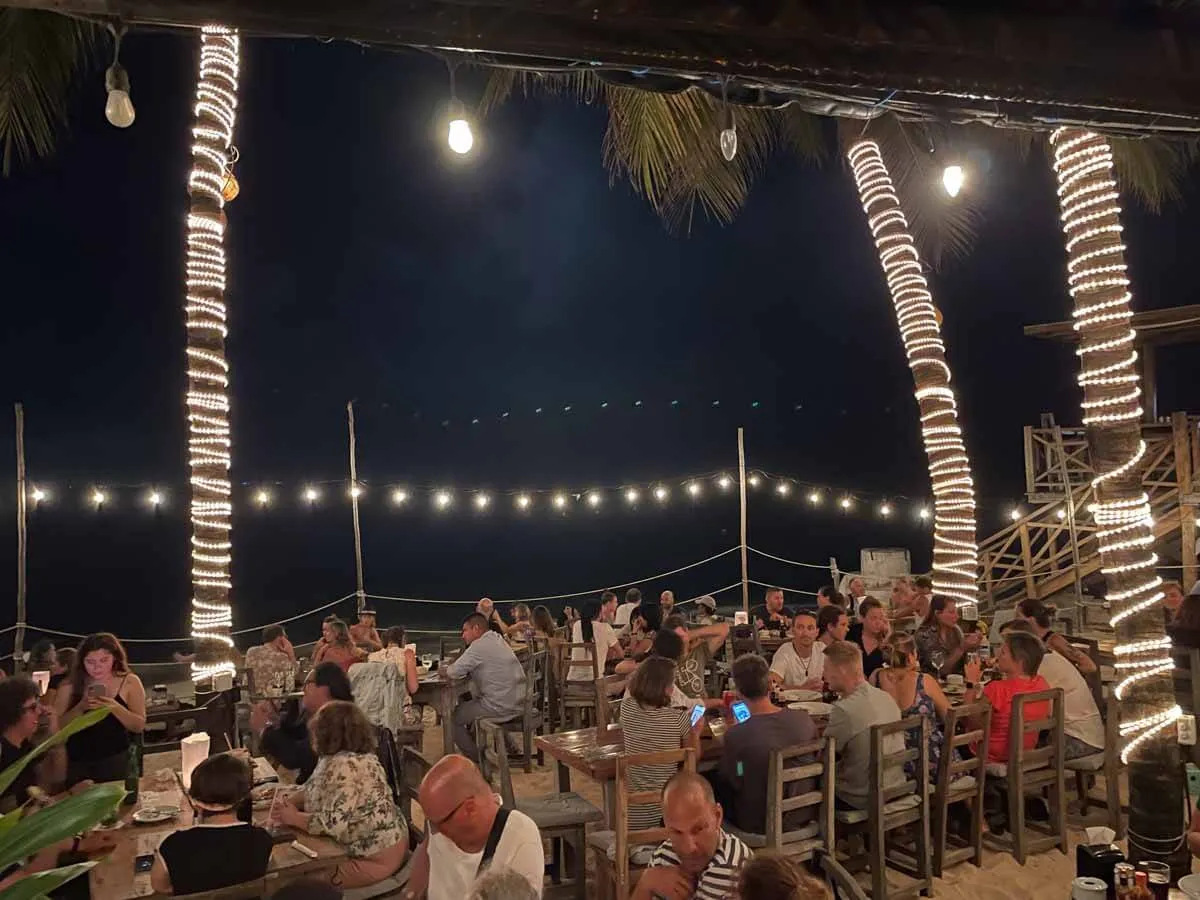 People dining at night at Zenzi Beach Restaurant in Playa del Carmen