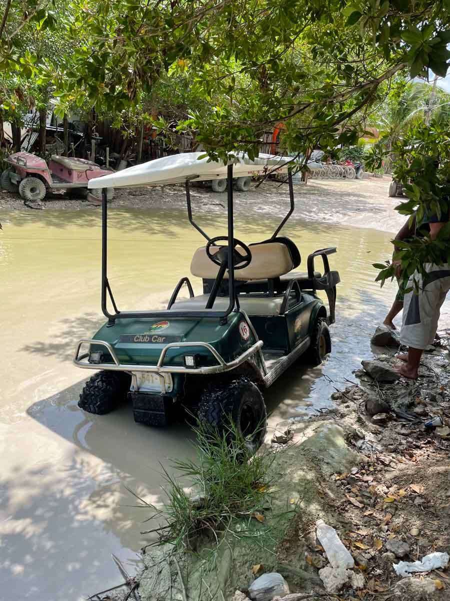 A golf cart stuck in the mud in Holbox Mexico