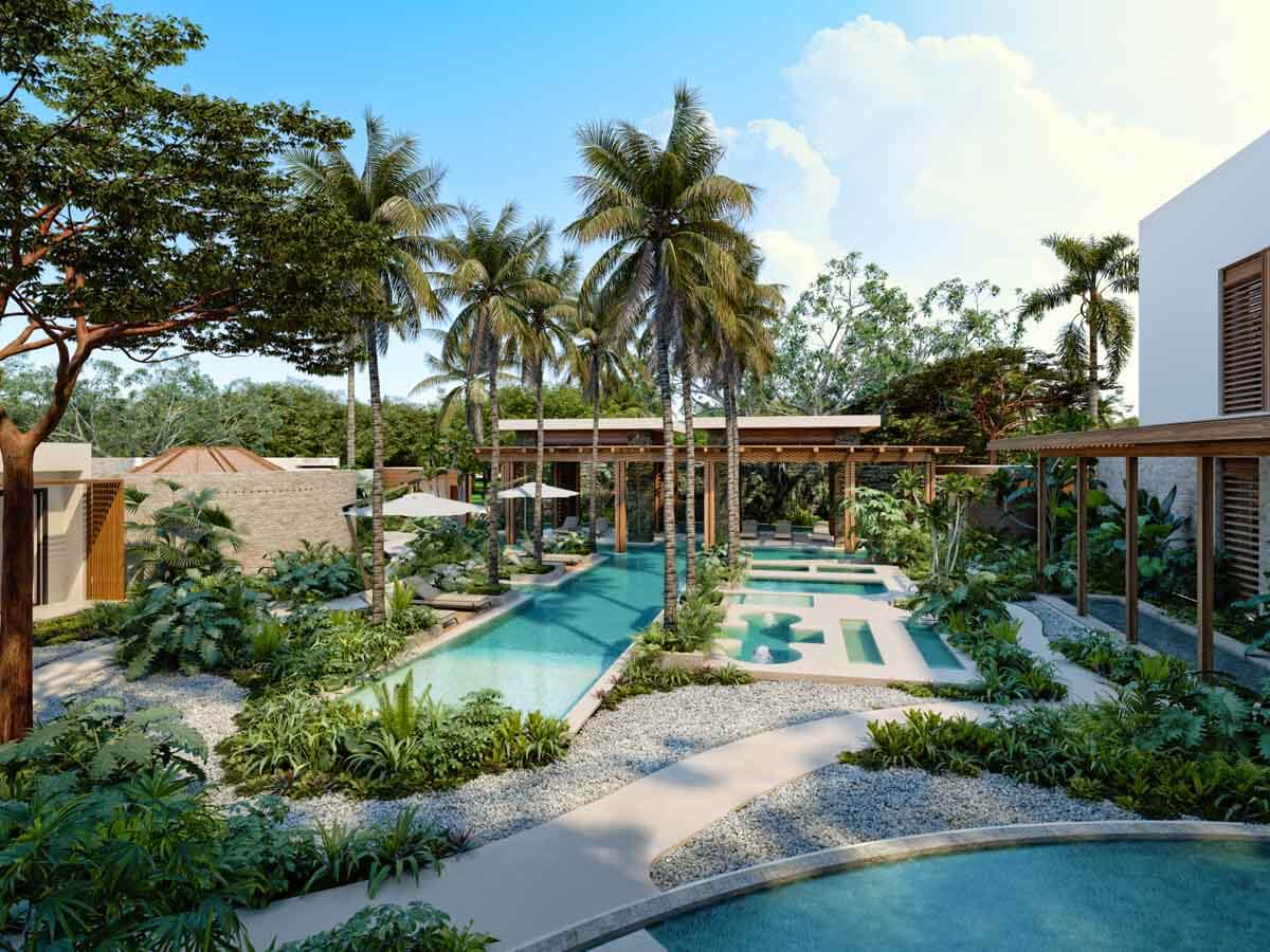 The outdoor hydrotherapy circuit surrounded by palm trees at Secrets Playa Blanca, a new Riviera Maya Mexico resort