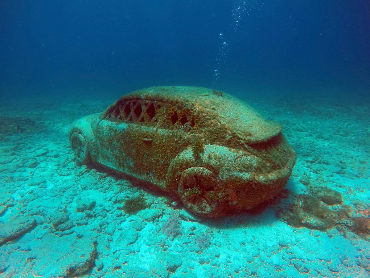 An underwater VW bug car at the MUSA Underwater Museum of Art
