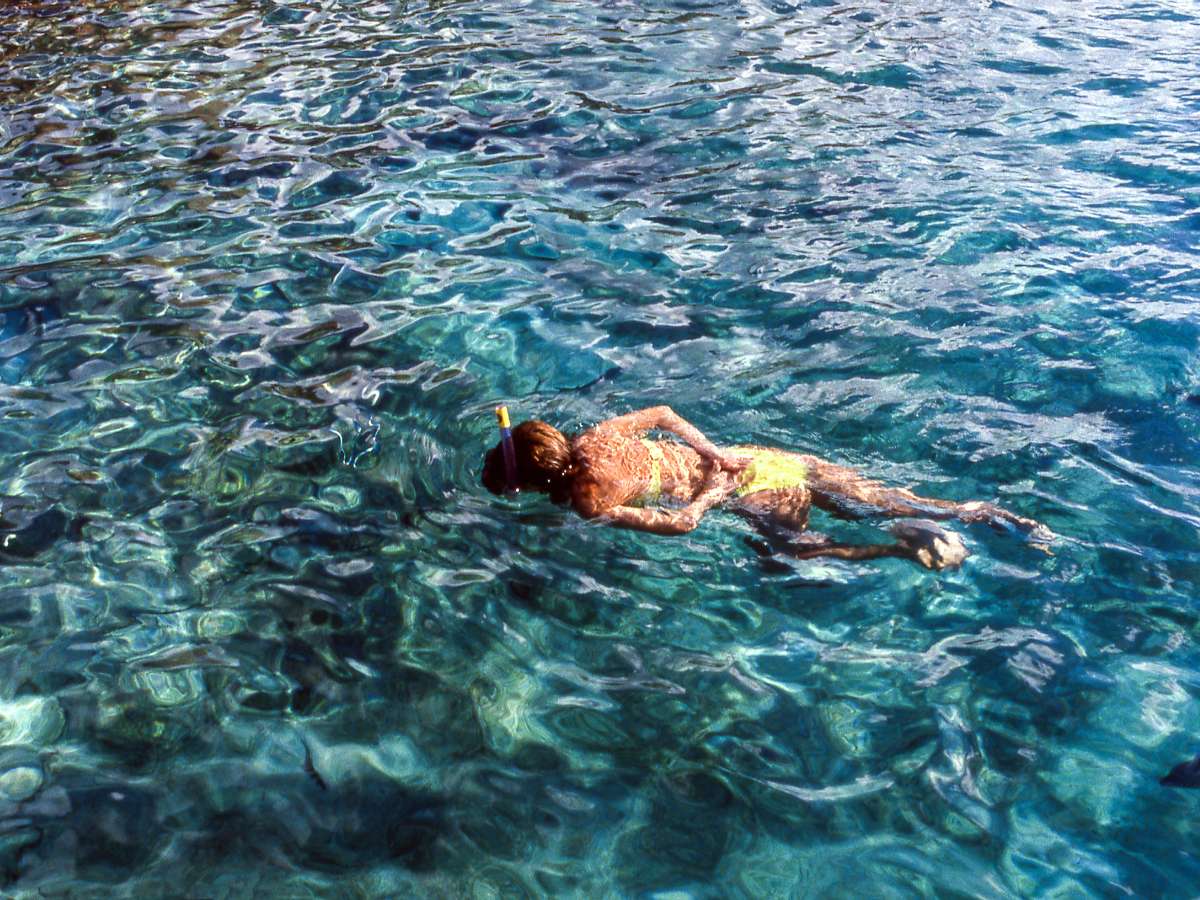 A woman snorkeling alone in the ocean