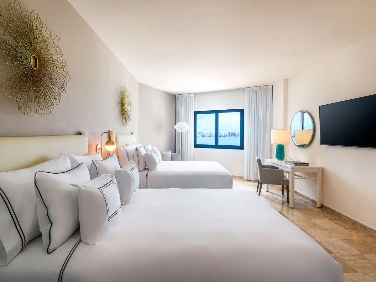 A guestroom with two beds at Melia Casa Maya Cancun resort