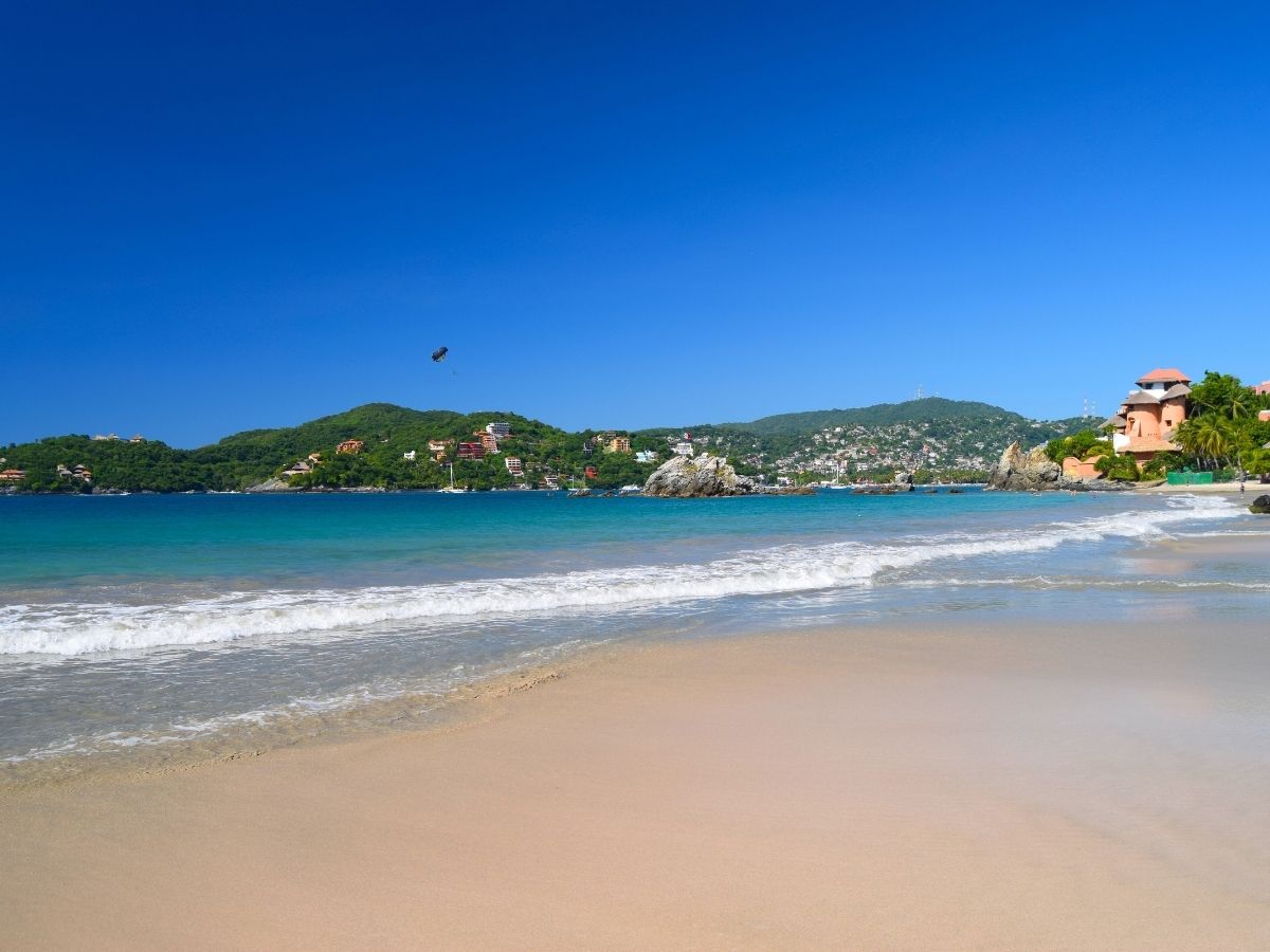 Playa La Ropa beach in Zihuatanejo with the surrounding hills in the background