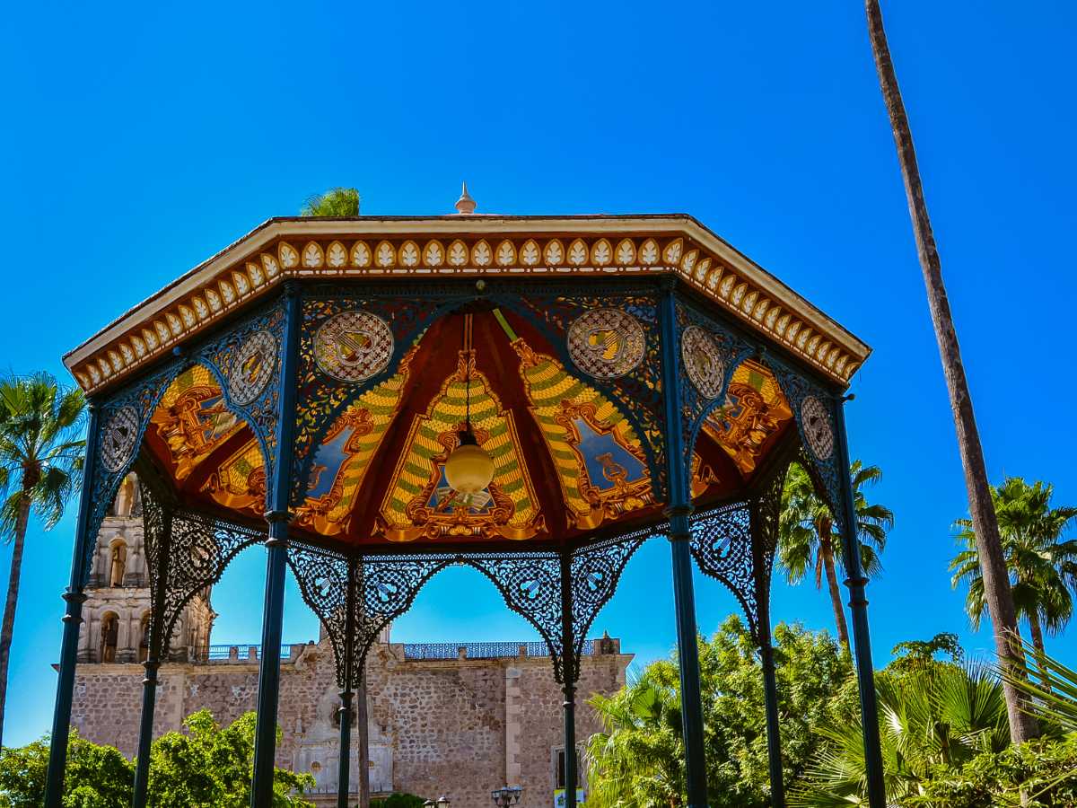 An intricately decorated gazebo in Alamos Mexico next to palm trees
