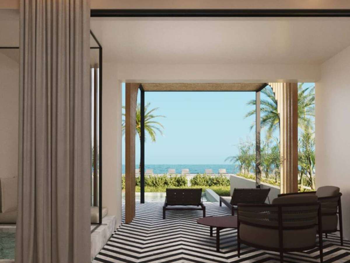 A guestroom with a terrace overlooking the ocean at Excellence Coral Playa Mujeres